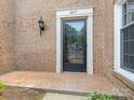 Inviting front entrance featuring a glass paneled door and brick paved porch at 6817 Dumbarton Dr, Charlotte, NC 28210