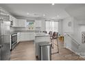 Bright kitchen with white cabinets, granite countertops, a stainless steel oven, and a kitchen island with barstool seating at 718 Dillon Way # 38, Fort Mill, SC 29715