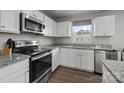 Modern kitchen featuring stainless steel appliances, granite countertops, ample cabinet space, and a window over the sink at 718 Dillon Way # 38, Fort Mill, SC 29715