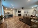 Open-concept living area with hardwood floors, a modern ceiling fan, and seamless flow into the kitchen and dining areas at 734 Herlong Ave, Rock Hill, SC 29732