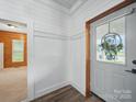 Entryway featuring wood floors, wooden door, and cottage-style design elements with ample lighting at 828 N Main St, Mount Pleasant, NC 28124