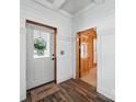 Entryway with wood floors, showing the front door and adjacent doorway, with cottage charm at 828 N Main St, Mount Pleasant, NC 28124