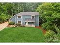 Blue two-story home with lush greenery and landscaping at 8338 Rittenhouse Cir, Charlotte, NC 28270