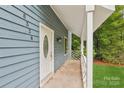 Close-up of the home's blue exterior and welcoming front porch at 8338 Rittenhouse Cir, Charlotte, NC 28270