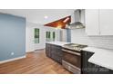 Modern kitchen featuring stainless steel appliances, sleek countertops, and wood flooring at 8338 Rittenhouse Cir, Charlotte, NC 28270