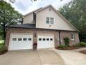 Spacious two-car garage featuring white doors and a brick exterior, offering ample parking and storage at 901 Brighton Dr, Kannapolis, NC 28081