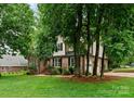 A beautiful view of the property showcasing a well-manicured lawn and mature trees at 901 Brighton Dr, Kannapolis, NC 28081