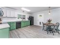 Functional eat-in kitchen with green and white cabinetry, modern appliances, and sleek, stylish flooring at 910 W A St, Kannapolis, NC 28081