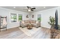 Cozy living room featuring stylish furniture, neutral decor, and ample natural light through large windows at 910 W A St, Kannapolis, NC 28081