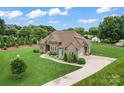 Beautiful exterior elevation of a two-story home showcasing stone accents, manicured lawn, and a paved driveway at 9125 Dylan Ridge Ct, Concord, NC 28027
