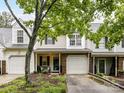 Charming townhome featuring a one-car garage, landscaped front yard, and a welcoming front porch at 9530 Elizabeth Townes Ln, Charlotte, NC 28277