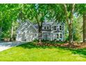 Charming two-story home featuring a two-car garage, manicured lawn, and mature trees at 9920 White Cascade Dr, Charlotte, NC 28269