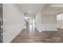 Elegant foyer with hardwood floors, wainscoting, and staircase leading to the upper level at 1048 Harbor Bay Dr, Indian Land, SC 29707