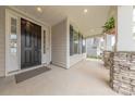 View of a home's front porch, showing stone pillars and a welcoming entryway at 1048 Harbor Bay Dr, Indian Land, SC 29707