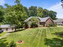 Beautifully landscaped brick home with a manicured lawn and a detached two-car garage, offering curb appeal at 10501 Mount Olive Dr # 7, Mount Pleasant, NC 28124