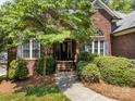 Inviting front entrance of a brick home, framed by manicured bushes and a walkway, creating curb appeal at 10501 Mount Olive Dr # 7, Mount Pleasant, NC 28124