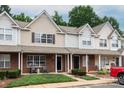 Two-story townhome boasts brick front, inviting porch area, and well-kept landscaping at 10548 English Setter Way, Charlotte, NC 28269
