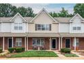 Charming townhome features brick facade, well-maintained landscaping, and cozy front porch at 10548 English Setter Way, Charlotte, NC 28269
