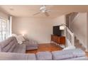 Cozy living room featuring hardwood floors, neutral color scheme, and staircase access at 10548 English Setter Way, Charlotte, NC 28269