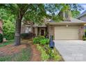 Charming brick home with manicured landscaping, a garage, and mailbox at 10607 Newberry Park Ln, Charlotte, NC 28277