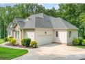 Well-maintained home exterior featuring a clean garage, lush landscaping, and a serene setting at 10874 Rise Ln, Fort Mill, SC 29707