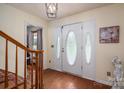 Foyer featuring hardwood floors, staircase, light fixture, and front door with decorative glass at 112 Ocean Dr, Shelby, NC 28152