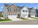 Charming townhome showcasing a well-maintained lawn and attached garage, blending style with convenience at 1229 Margo Mannor Dr, Fort Mill, SC 29708
