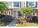 Charming townhome featuring a welcoming covered porch and professionally landscaped front yard at 127 Walnut Cove Dr # D, Mooresville, NC 28117