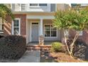 Inviting front porch with brick columns and fresh landscaping leading to the entrance at 127 Walnut Cove Dr # D, Mooresville, NC 28117