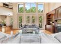 Bright living room featuring large windows, hardwood floors, and modern furnishings at 1405 Saratoga Woods Dr, Waxhaw, NC 28173
