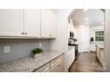 Well-lit kitchen featuring granite countertops, stainless appliances, and subway tile backsplash at 150 W Morehouse Ave, Mooresville, NC 28117