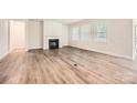 Bright living room with a fireplace, hardwood floors, and large windows at 1540 Croydon St, Indian Land, SC 29707