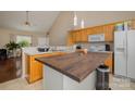 Spacious kitchen with vaulted ceiling, light wood cabinets, an island, and an open layout for easy entertaining at 159 Pitts School Nw Rd, Concord, NC 28027