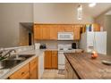 Functional kitchen featuring wood cabinets, modern appliances, an island with seating, and lots of counter space at 159 Pitts School Nw Rd, Concord, NC 28027