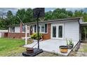 Front exterior of a well-maintained home with a cozy entrance and easy access parking at 1691 Hill River Rd, Hiddenite, NC 28636