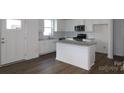 Bright kitchen with white cabinets, granite countertops, stainless steel appliances, and an island at 1922 Highland Park Dr, Charlotte, NC 28269