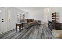 Bright living room with stylish wood floors, bay window, and a cozy sofa at 2315 Circle Dr, Great Falls, SC 29055
