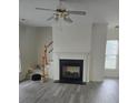 Cozy living room with a fireplace, a ceiling fan and wood stairs at 2924 Sedona Pl, Fort Mill, SC 29708