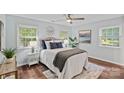 Bright main bedroom with large windows, ceiling fan, and neutral decor at 3308 Selwyn Farms Ln # 5, Charlotte, NC 28209