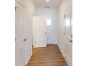 Bright hallway featuring hardwood floors and white trim throughout at 4009 Lawnview Dr, Charlotte, NC 28269
