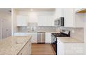 Modern kitchen featuring granite countertops, stainless steel appliances, and a stylish backsplash at 4009 Lawnview Dr, Charlotte, NC 28269