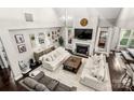 Open-concept living room featuring vaulted ceilings, a fireplace, and stylish furnishings at 4189 Island Fox Ln, Denver, NC 28037