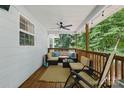 Relaxing covered porch with ample seating, string lights, and views of the private backyard at 4230 Train Chaser Pl, Indian Land, SC 29707