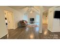 Open-concept living room with vaulted ceiling, hardwood floors, and a cozy seating arrangement at 4317 Waxhaw Indian Trail Rd, Indian Trail, NC 28079