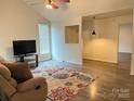Inviting living room featuring hardwood floors, a ceiling fan, and a comfortable seating area at 4317 Waxhaw Indian Trail Rd, Indian Trail, NC 28079