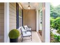 Relaxing covered porch featuring comfortable seating and decorative plants at 4323 Bright Rd, Charlotte, NC 28214