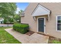 A cozy, covered doorway entrance featuring well-maintained landscaping and inviting appeal at 4557 Panther Pl, Charlotte, NC 28269