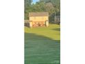 View of the back of the condo with a large grassy yard and outdoor seating area at 484 Willow Spring Ln # A, Rock Hill, SC 29730