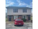 Two-story condo building with vinyl siding, brick facade, and a parked red sedan at 484 Willow Spring Ln # A, Rock Hill, SC 29730