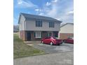 Two-story condominium with vinyl siding, brick facade, and a paved parking area at 484 Willow Spring Ln # A, Rock Hill, SC 29730
